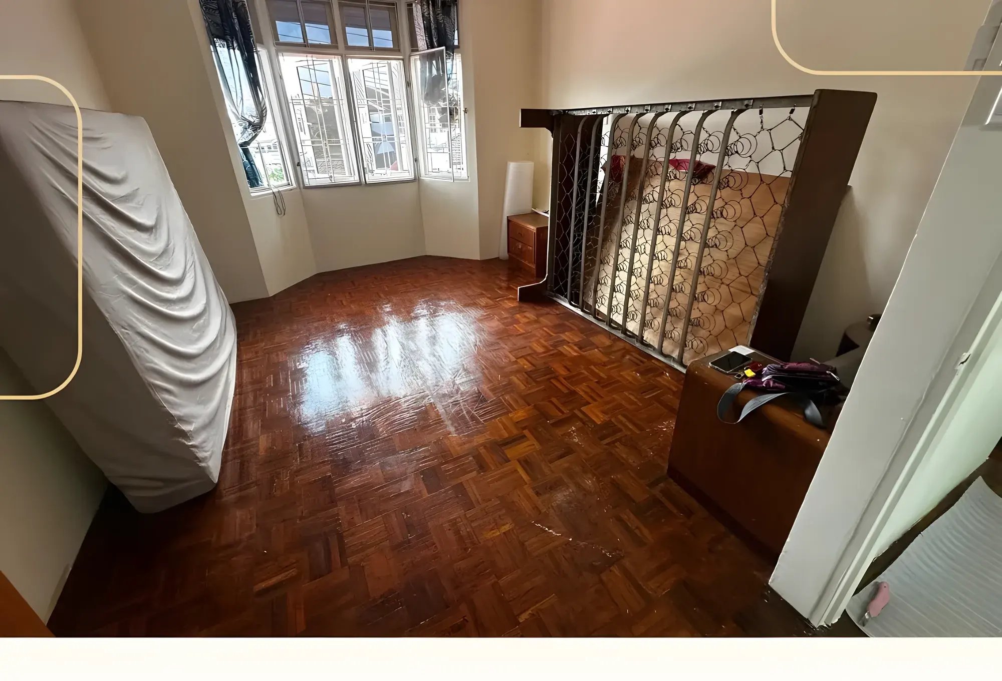 Bedroom before: worn dark parquet flooring.