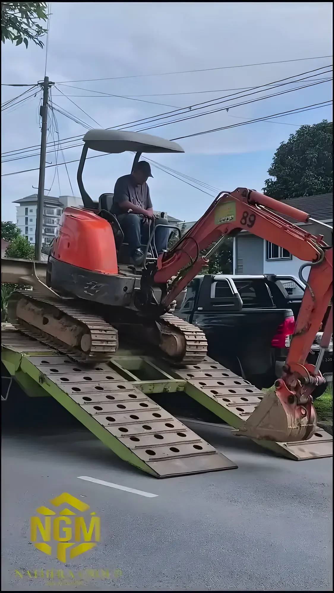 Mini excavator being unloaded from a lorry at the start of the job.