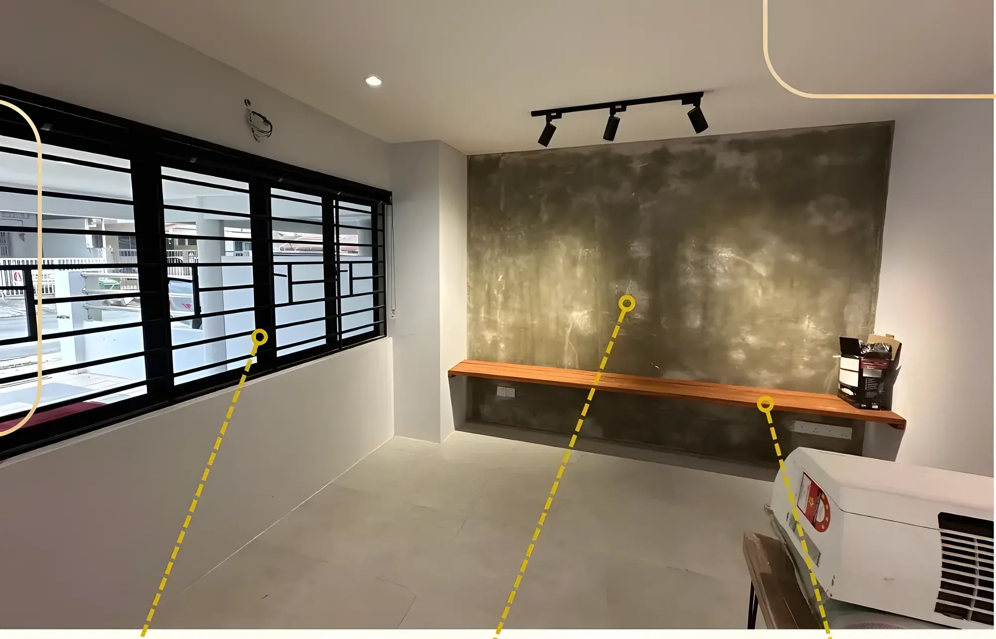 Smooth skim-coat feature wall with a floating TV console, beside new aluminium windows with iron grilles.