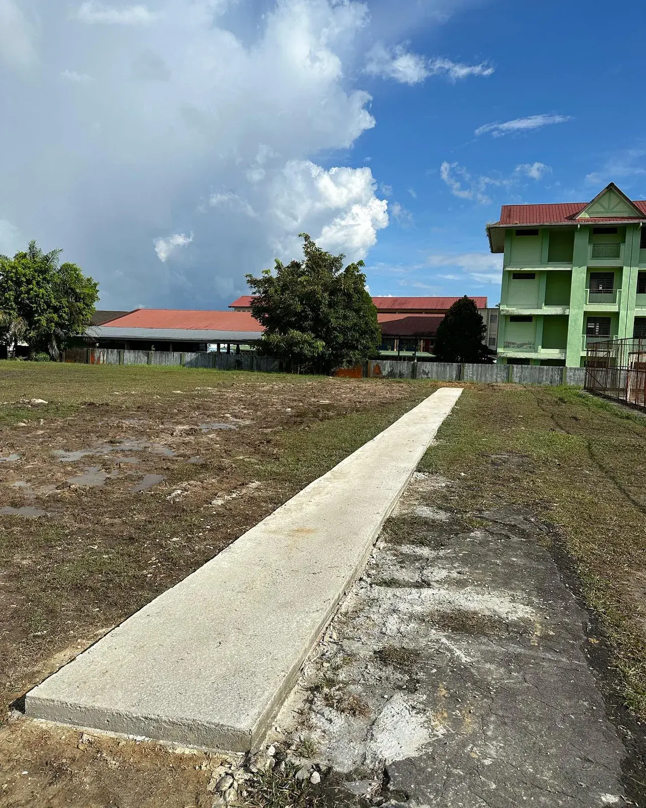 The new concrete runway leading to the long jump pit on the school field.