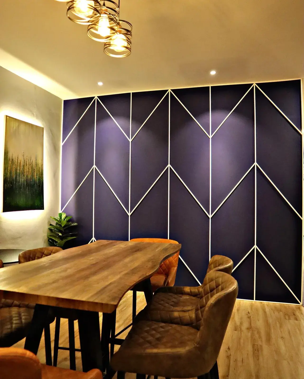 Café-style pantry with a live-edge timber table and a dark geometric feature wall.