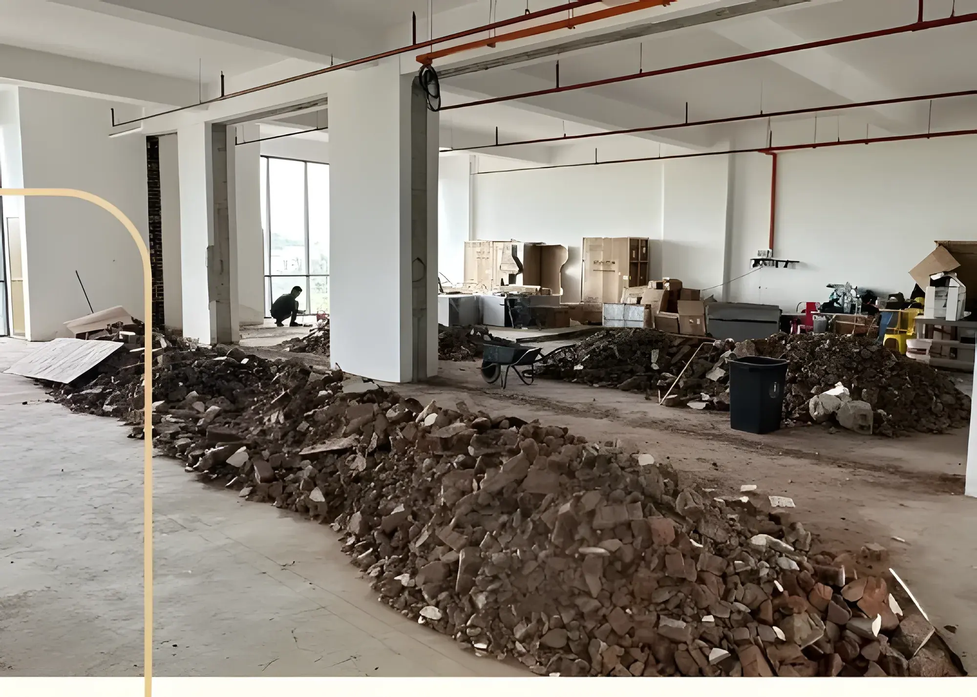 Two shop lots opened into one floor, rubble heaped to one side.