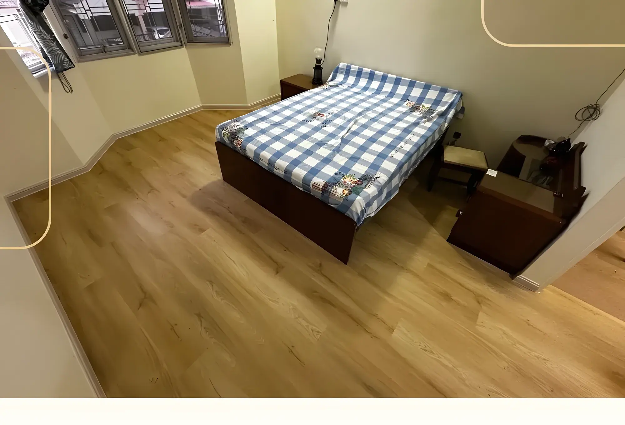 Bedroom after: light oak SPC flooring laid over the old parquet.